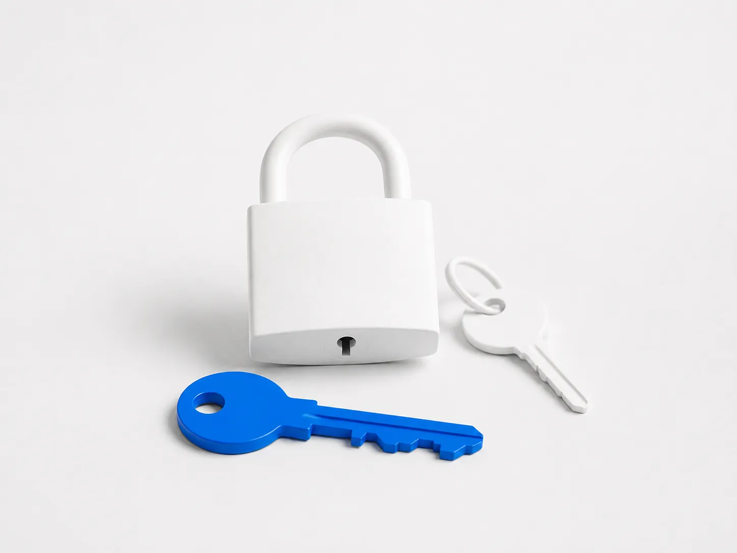 A blue key lies in front of a white padlock, with a second white key beside it